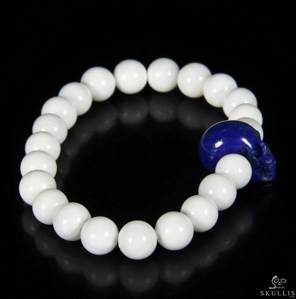 The Harmonious Pulse - Tridacna Gigas Beads Stretch Bracelet with Hand-Carved Lapis Lazuli Skull, Crystal Healing Skull Jewelry, for Women & Men The Harmonious Pulse - Tridacna Gigas Beads Stretch Bracelet with Hand-Carved Lapis Lazuli Skull, Crystal Healing Skull Jewelry, for Women & Men