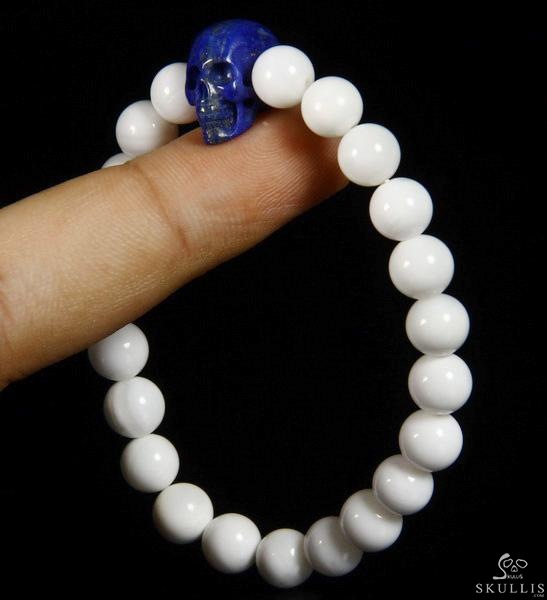 The Harmonious Pulse - Tridacna Gigas Beads Stretch Bracelet with Hand-Carved Lapis Lazuli Skull, Crystal Healing Skull Jewelry, for Women & Men The Harmonious Pulse - Tridacna Gigas Beads Stretch Bracelet with Hand-Carved Lapis Lazuli Skull, Crystal Healing Skull Jewelry, for Women & Men