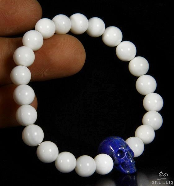 The Harmonious Pulse - Tridacna Gigas Beads Stretch Bracelet with Hand-Carved Lapis Lazuli Skull, Crystal Healing Skull Jewelry, for Women & Men The Harmonious Pulse - Tridacna Gigas Beads Stretch Bracelet with Hand-Carved Lapis Lazuli Skull, Crystal Healing Skull Jewelry, for Women & Men