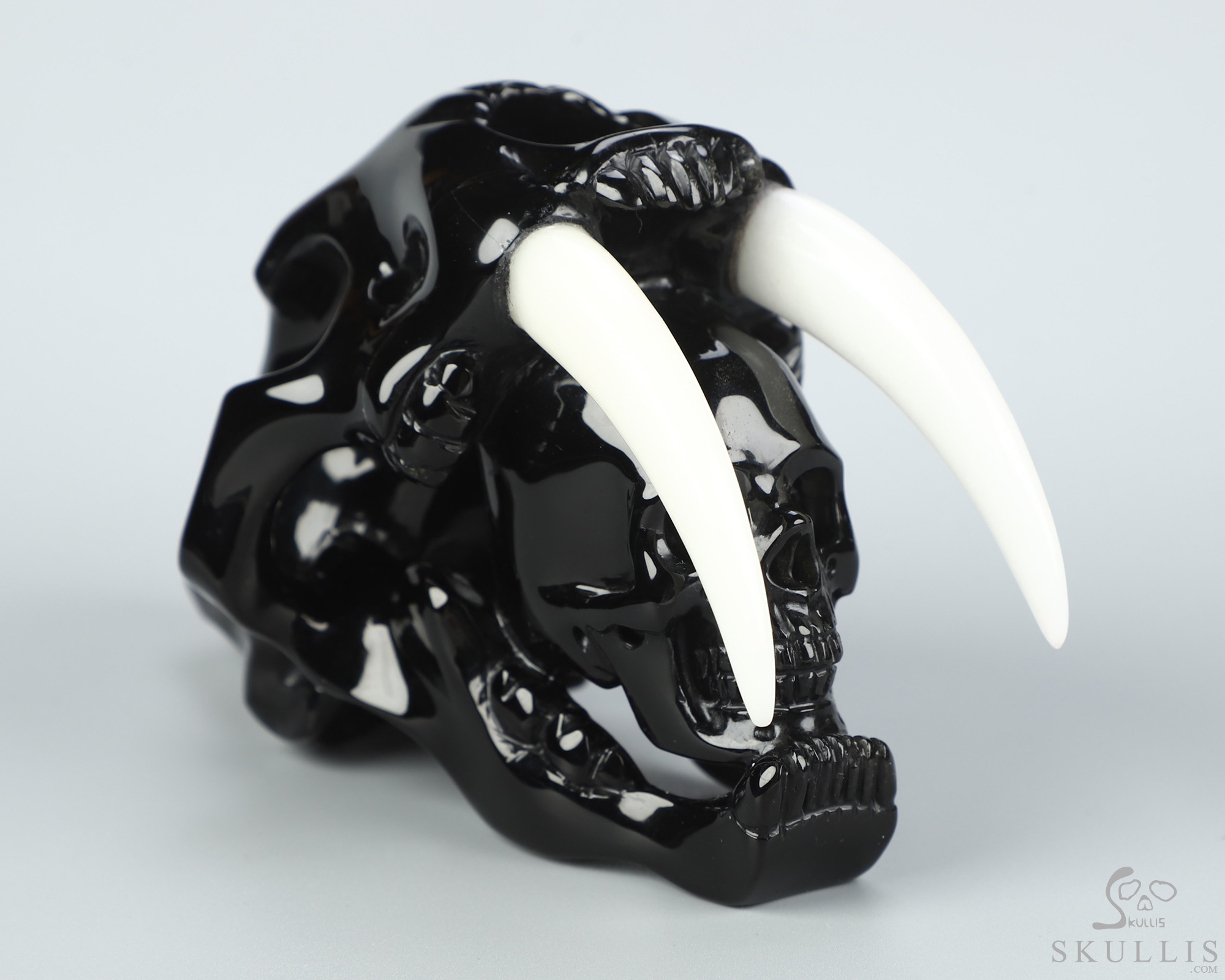 5.1" Black Obsidian Hand Carved Crystal Smilodon SABER-TOOTHED Tiger/Cat Skull and White Jade Tooth Sculpture 5.1" Black Obsidian Hand Carved Crystal Smilodon SABER-TOOTHED Tiger/Cat Skull and White Jade Tooth Sculpture