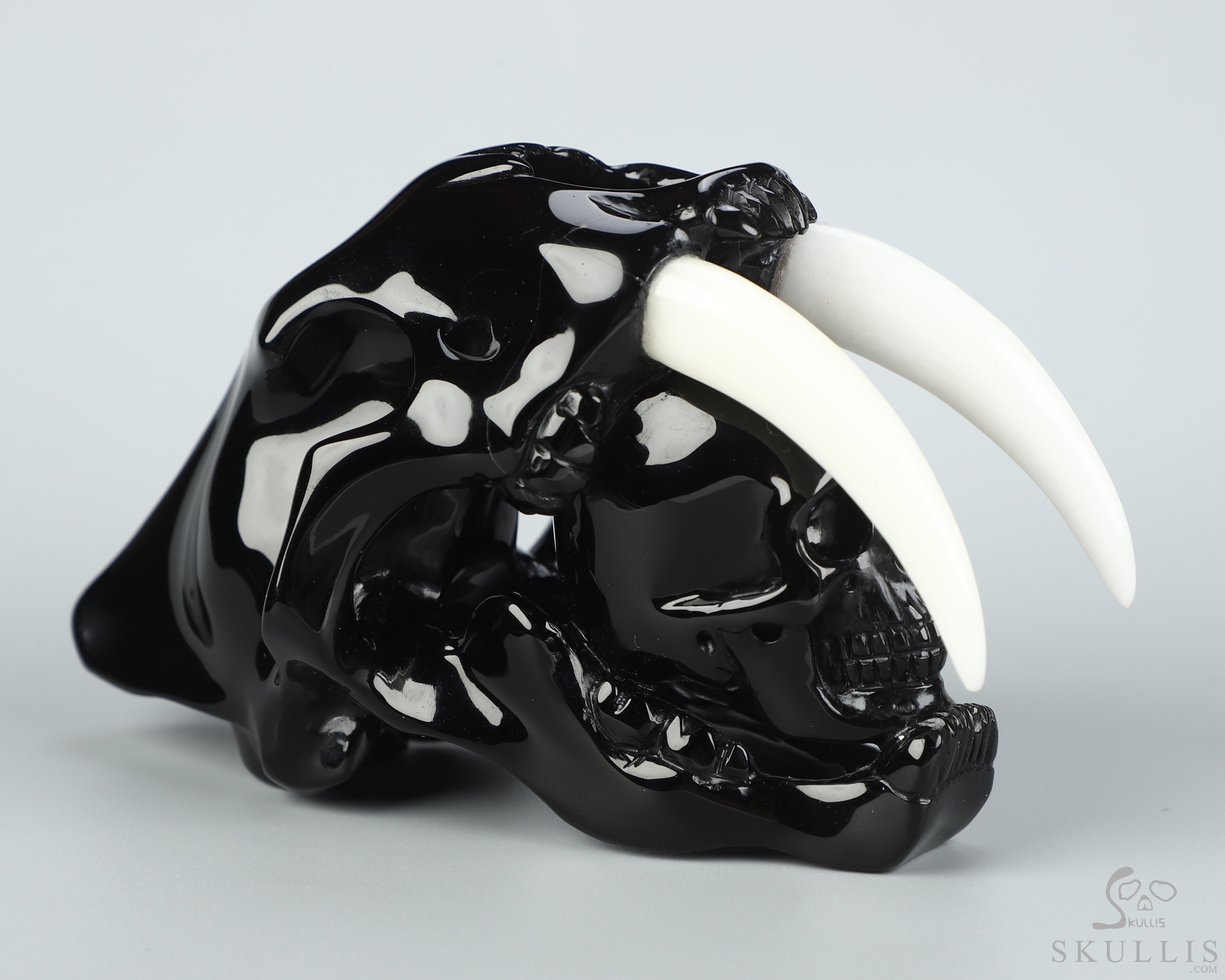 5.1" Black Obsidian Hand Carved Crystal Smilodon SABER-TOOTHED Tiger/Cat Skull and White Jade Tooth Sculpture 5.1" Black Obsidian Hand Carved Crystal Smilodon SABER-TOOTHED Tiger/Cat Skull and White Jade Tooth Sculpture